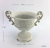 8.5” high White urn METAL with pattern in the middle